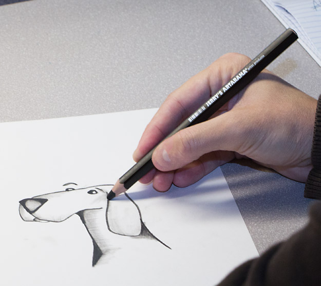 artist drawing with a charcoal pencil