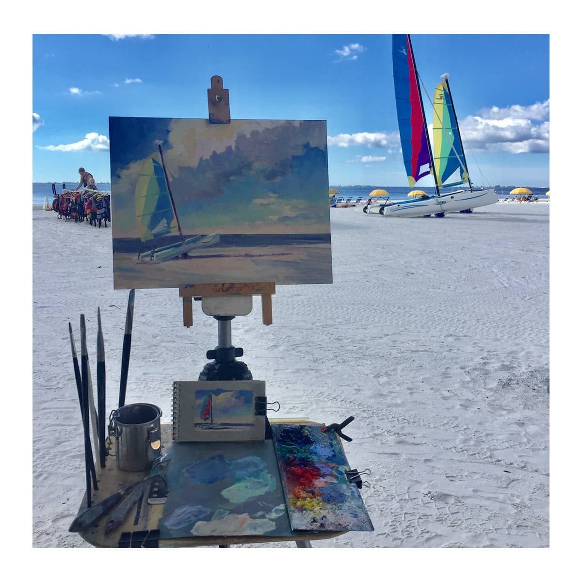 Artist Linda Richichi painting on Gessobord at the beach