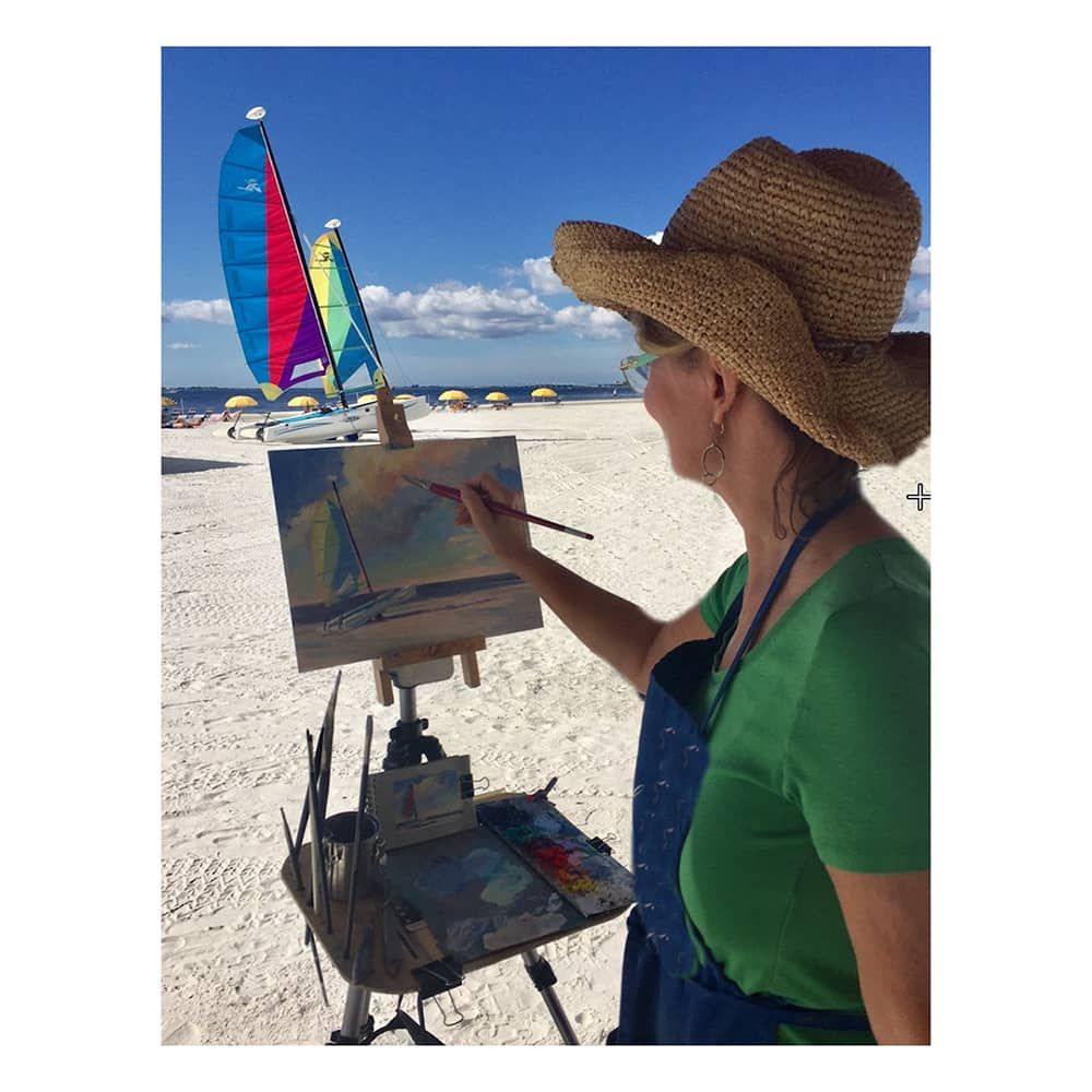 Artist Linda Richichi painting on Gessobord at the beach